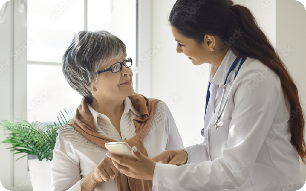 Doctor showing elderly woman something on her phone